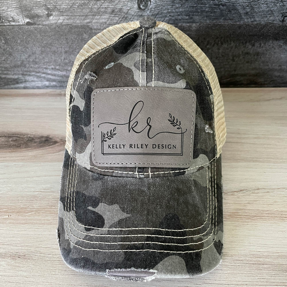 
                  
                    Distressed Camouflage Cap with Engraved Leather Patch
                  
                