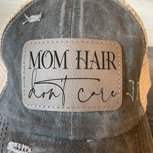 
                  
                    Mom Hair Don't Care | Women's Distressed Pony Cap with Engraved Leather Patch
                  
                